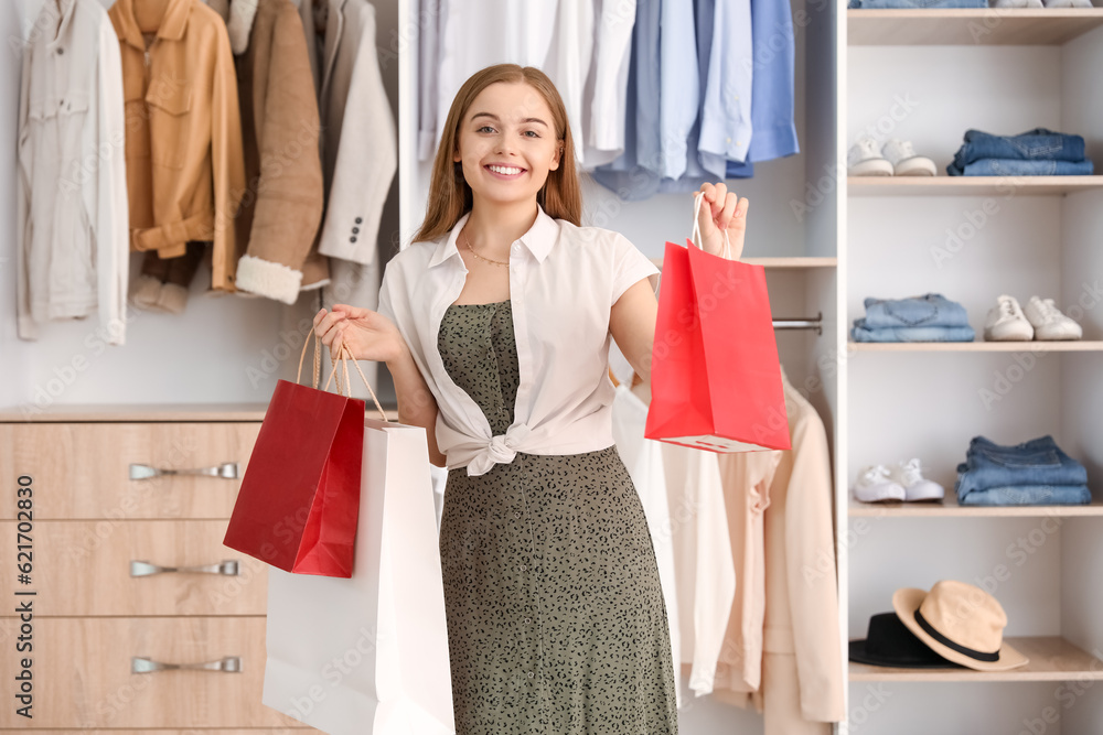 Young woman with shopping bags in boutique