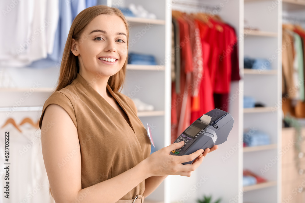 Female seller with payment terminal in boutique