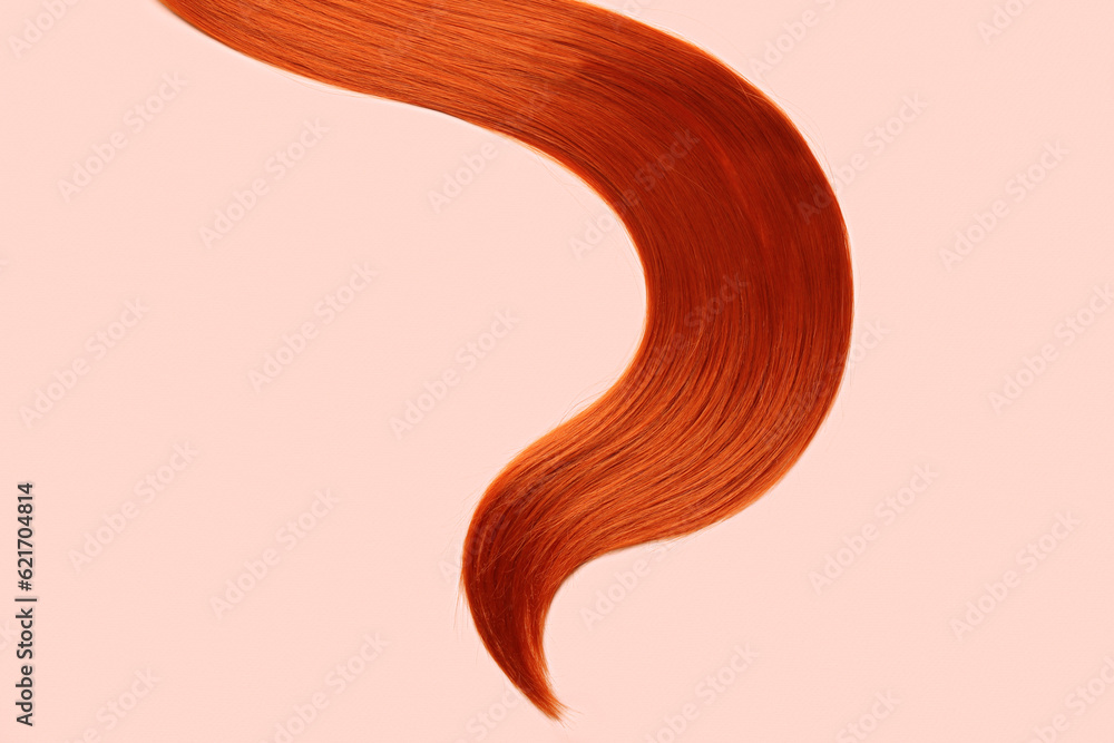 Ginger hair strand on color background, closeup