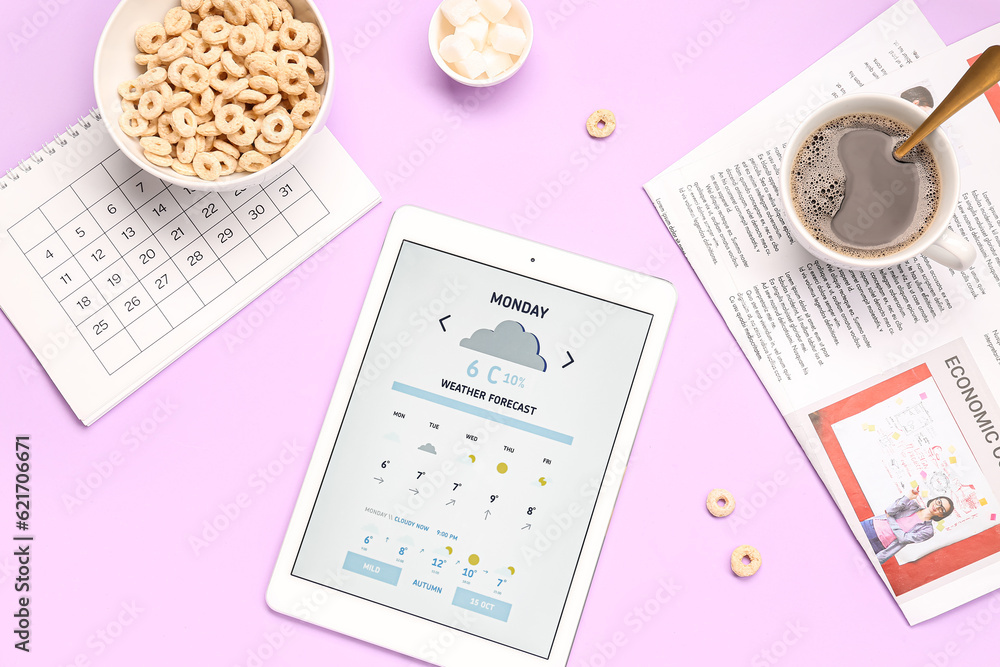 Tablet computer with weather forecast, breakfast, calendar and newspaper on lilac background