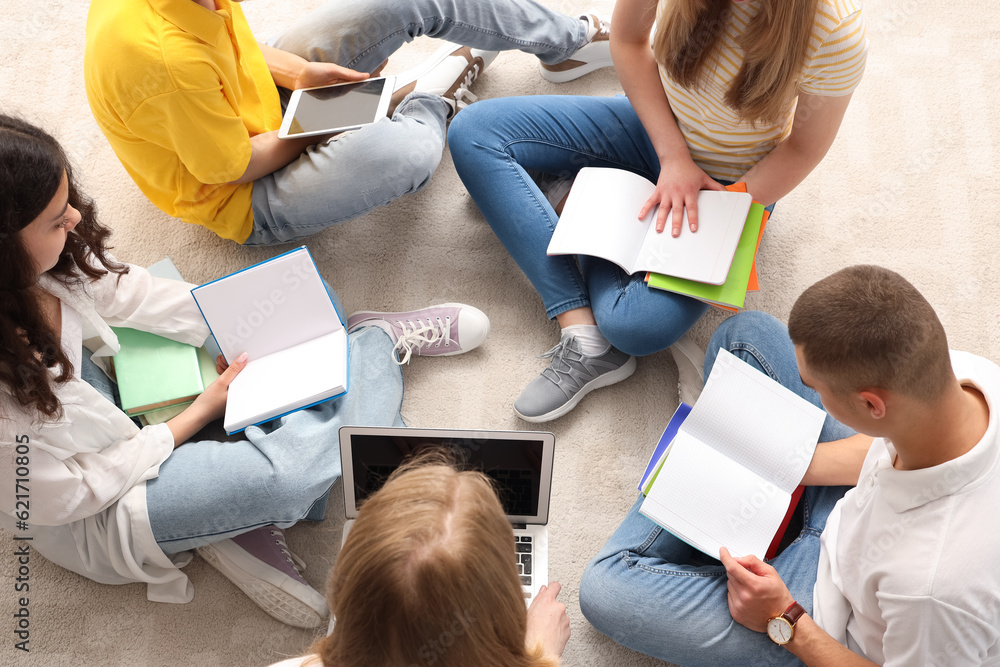 Group of students doing homework in room, top view