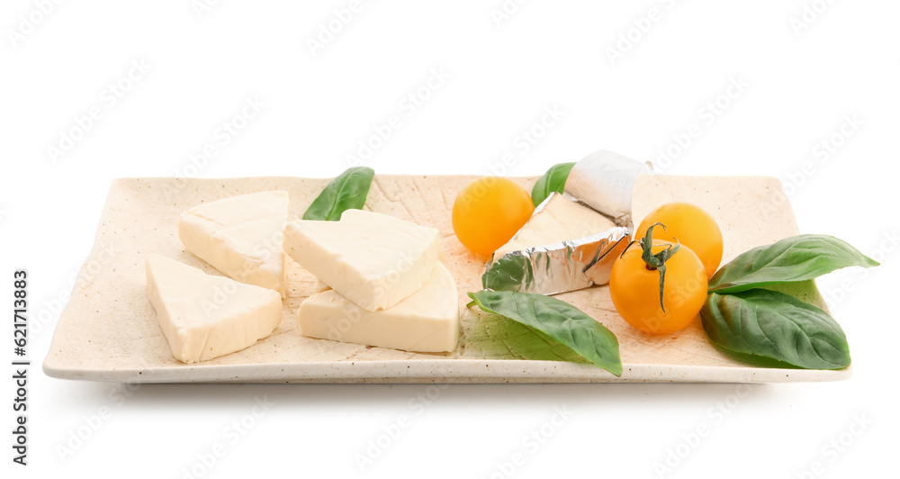 Plate with triangles of tasty processed cheese, cherry tomatoes and basil leaves on white background