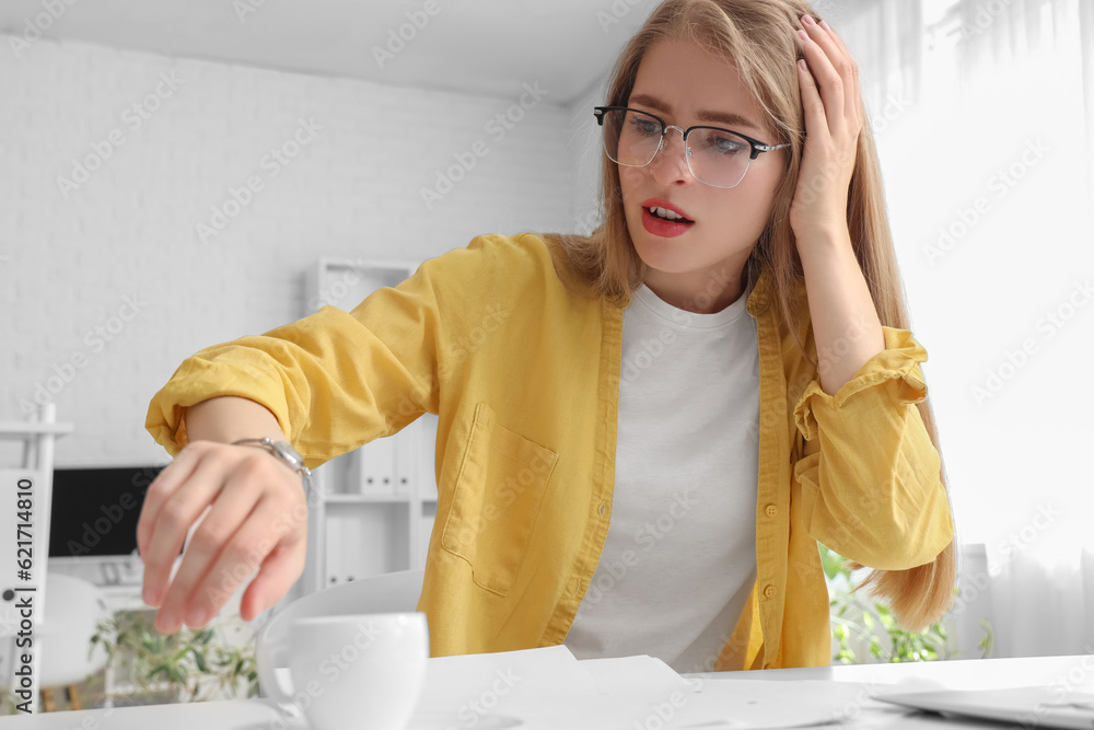 Stressed young businesswoman working under deadline in office