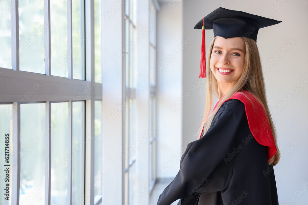 Female graduate student near window in room