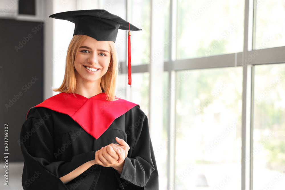 Female graduate student near window in room