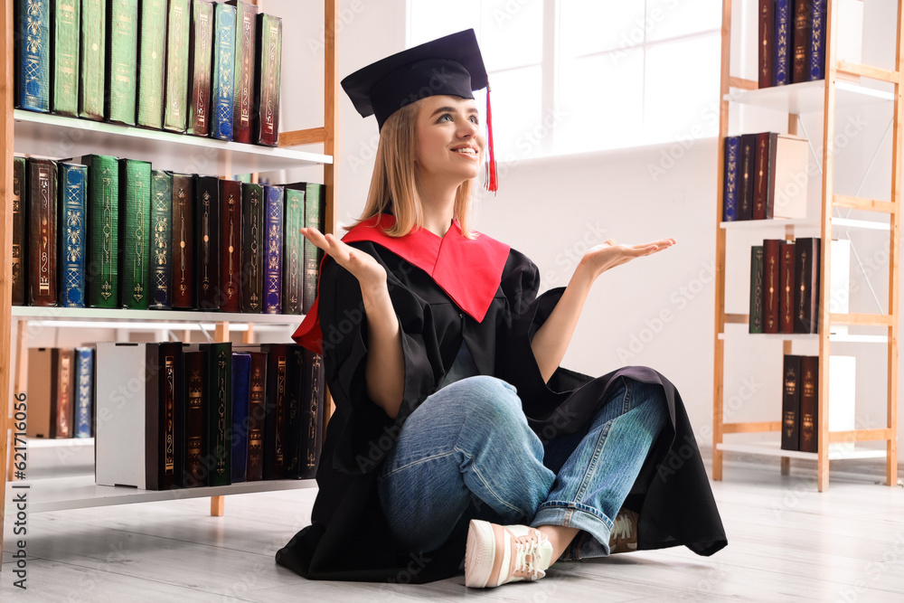 Female graduate student sitting in library