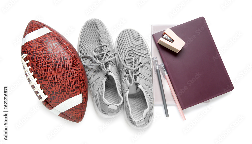 Sneakers with rugby ball and different stationery isolated on white background