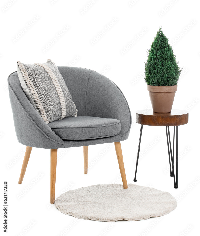 Grey armchair with table and rug on white background