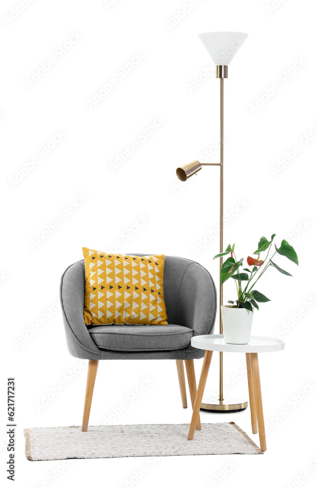 Grey armchair with table, lamp and rug on white background