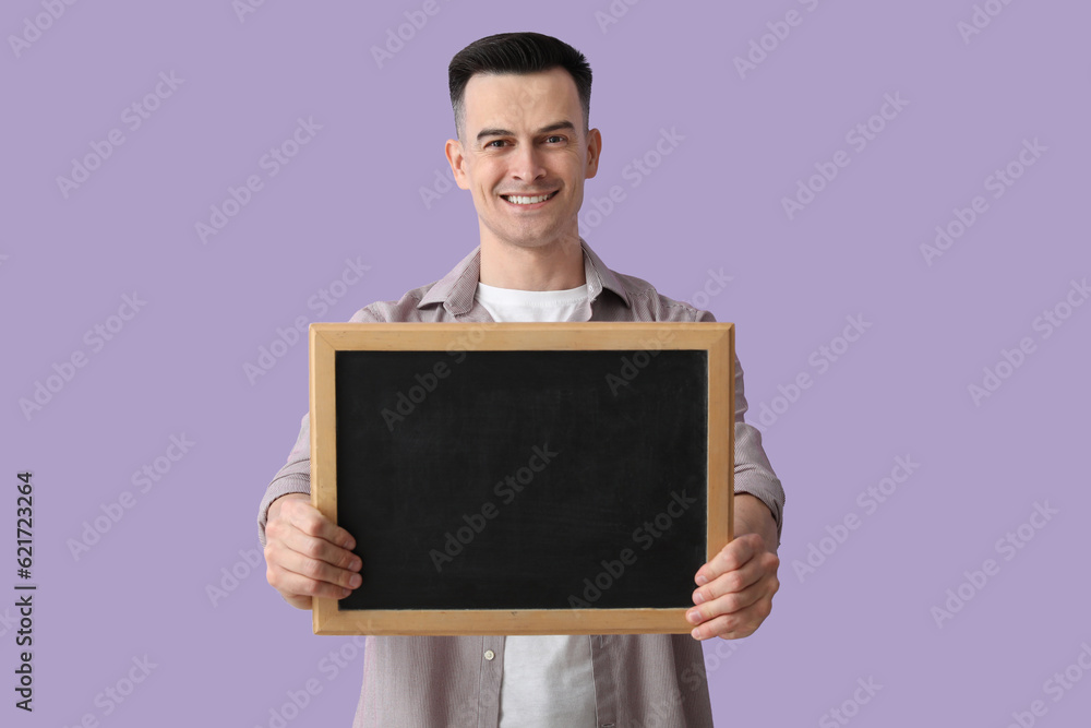 Male teacher with chalkboard on lilac background