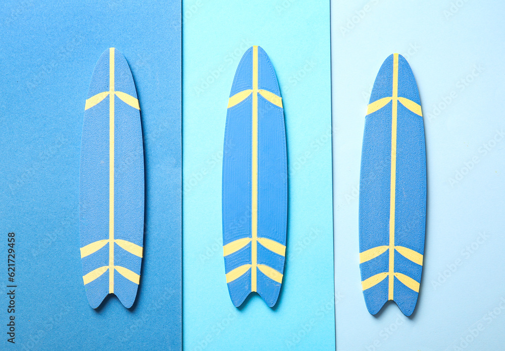 Mini surfboards on color background