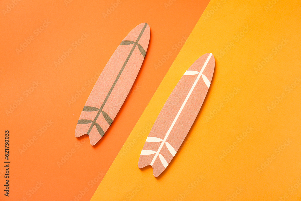 Mini surfboards on color background