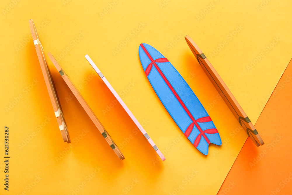 Mini surfboards on color background