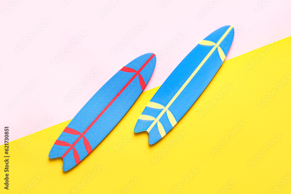 Mini surfboards on color background