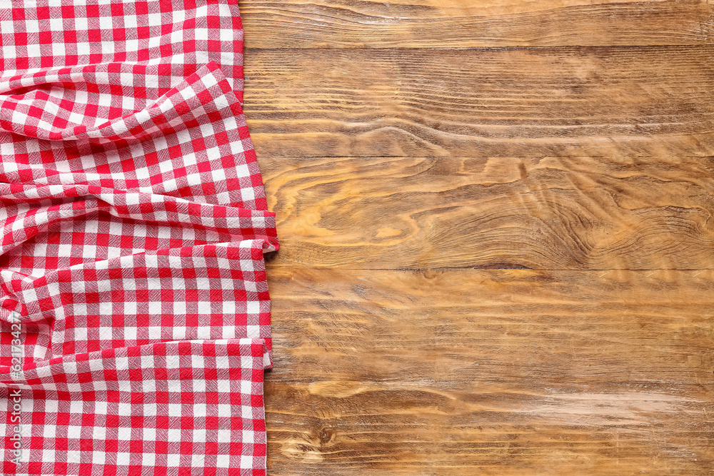 Crumpled red napkin on wooden background