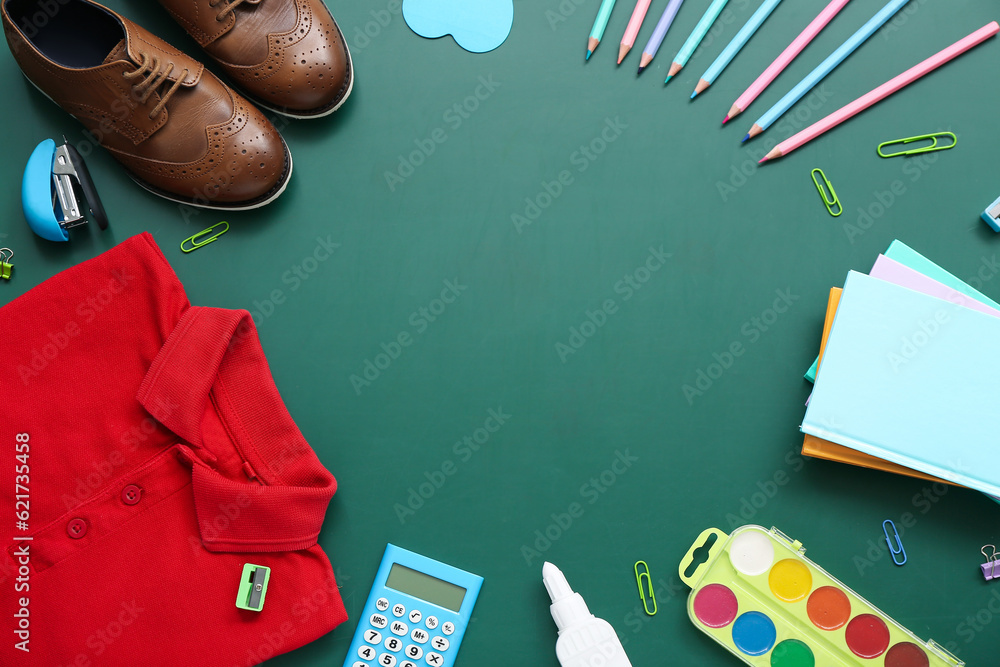 Frame made of different stationery and stylish school uniform on green chalkboard