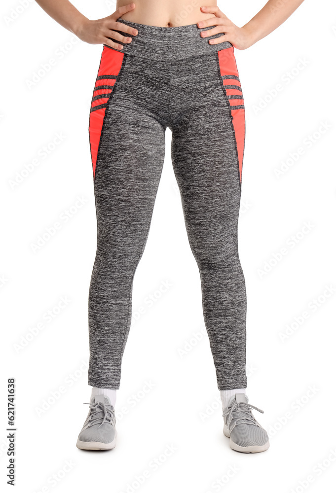 Sporty young woman in leggings on  white background