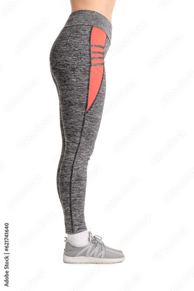 Sporty young woman in leggings on  white background