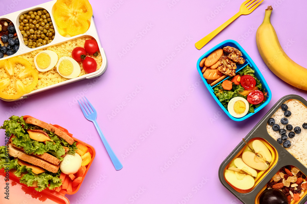 Lunchboxes with different tasty food on lilac background