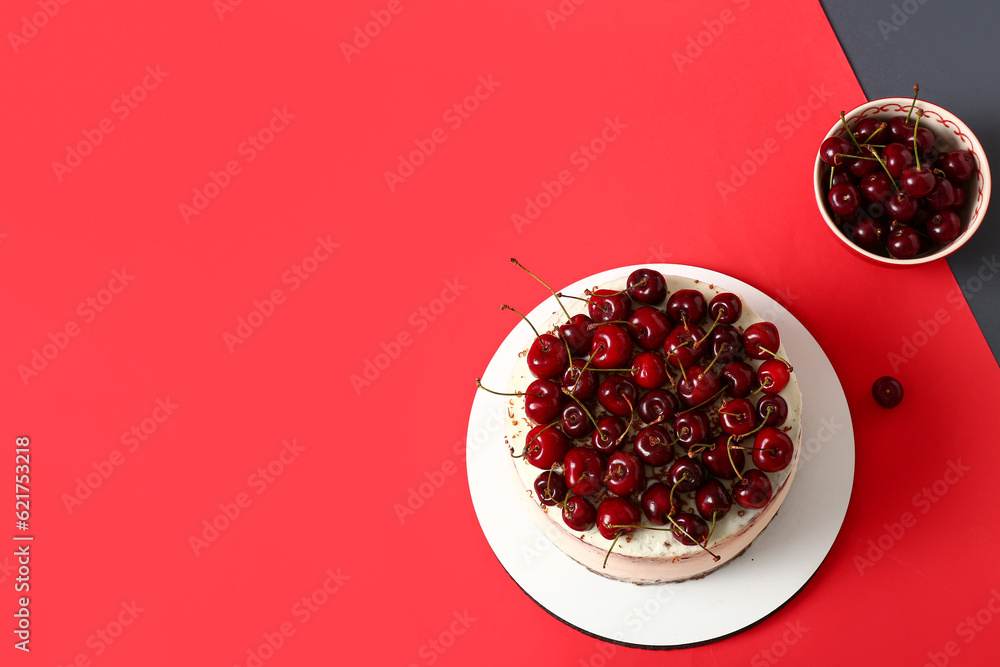 Board with tasty cherry cake on color background