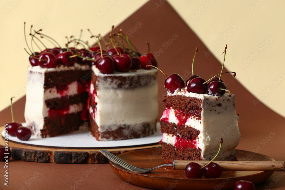 Plate with piece of tasty cherry cake on color background