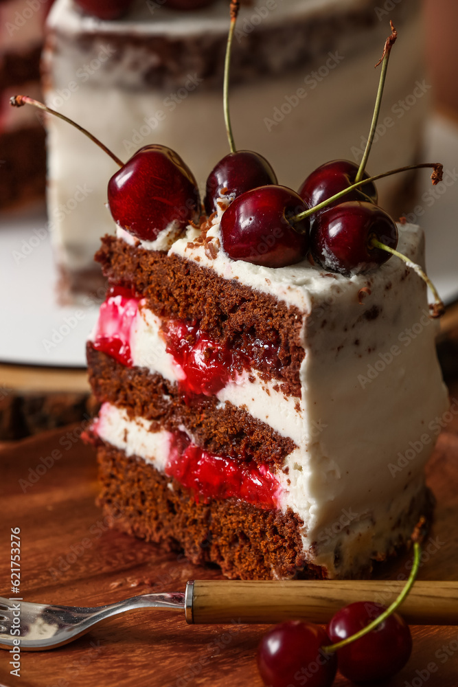 Plate with piece of tasty cherry cake on table