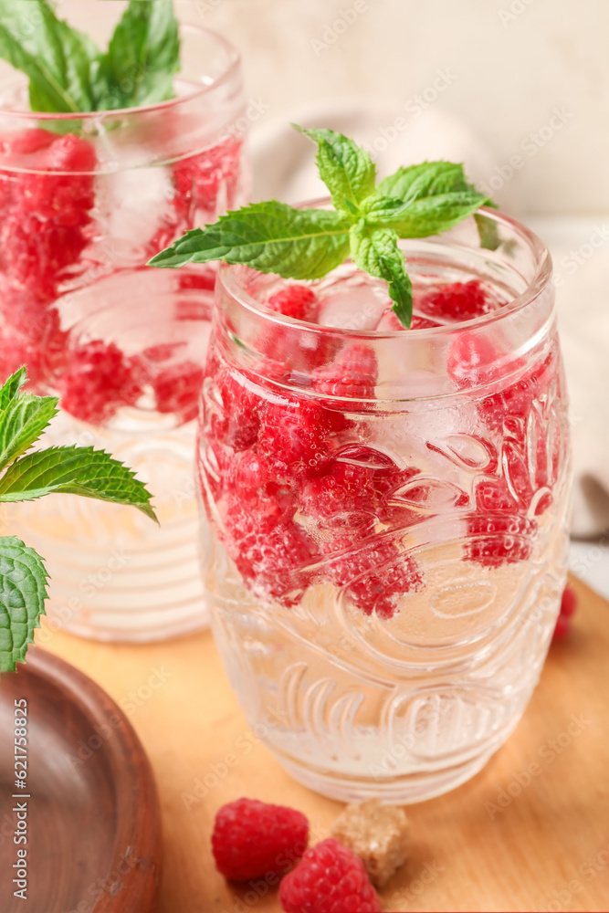 Glasses of fresh raspberry lemonade with mint on white background, closeup