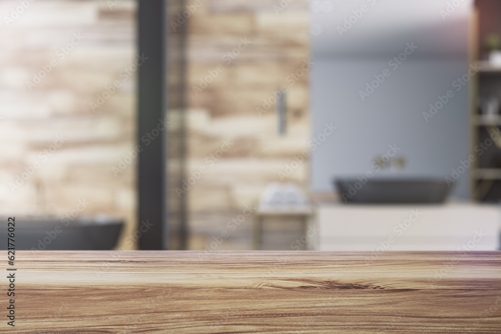 Front view of empty wooden countertop in bathroom interior with blurred background, product presenta