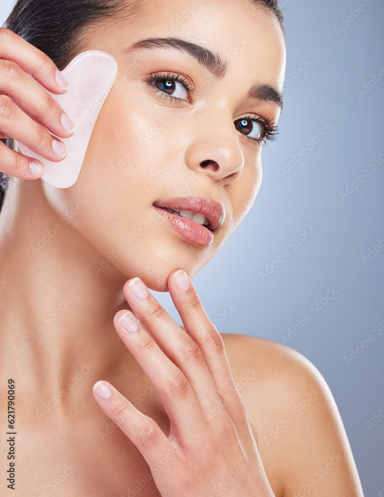 Gua sha, crystal and portrait of asian woman with skincare tool in studio for anti aging or fine lin