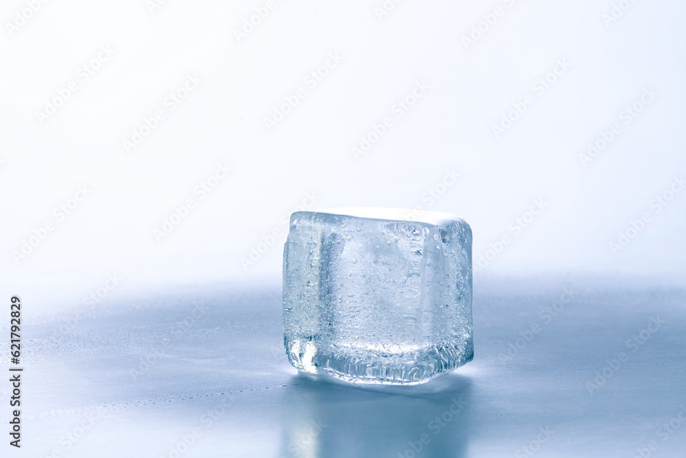 a cube of ice on blue background.