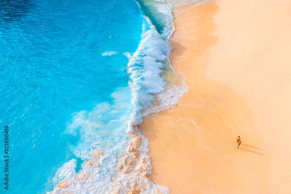 An aerial view of the people on the beach. Coast as a background from top view.  Waves and beach. Se