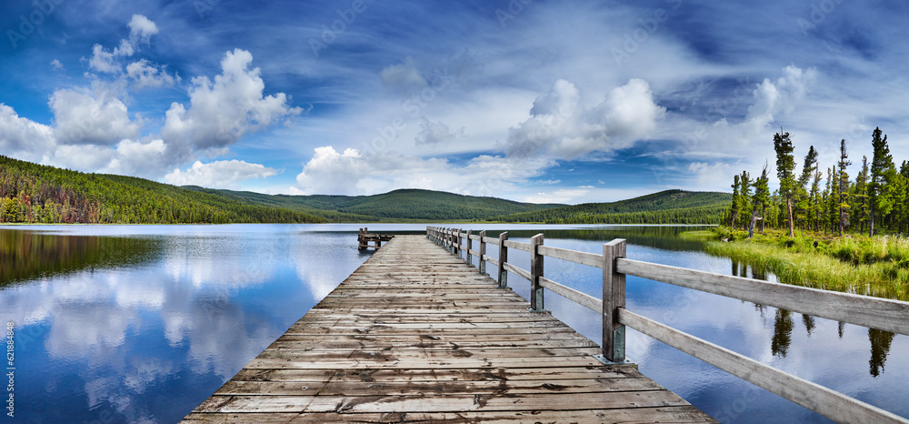 Mountain lake with reflection and wooden pier