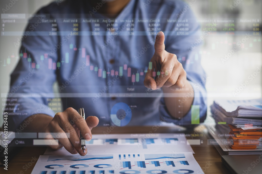 Businessman at office desk analyzing financial markets and planning investment business.