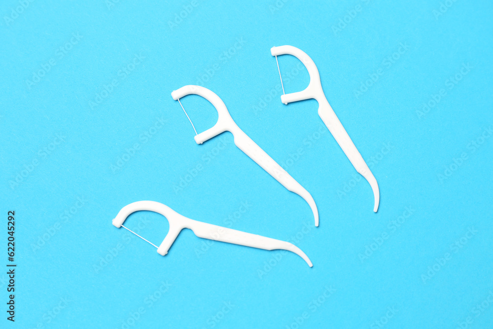 Floss toothpicks on blue background