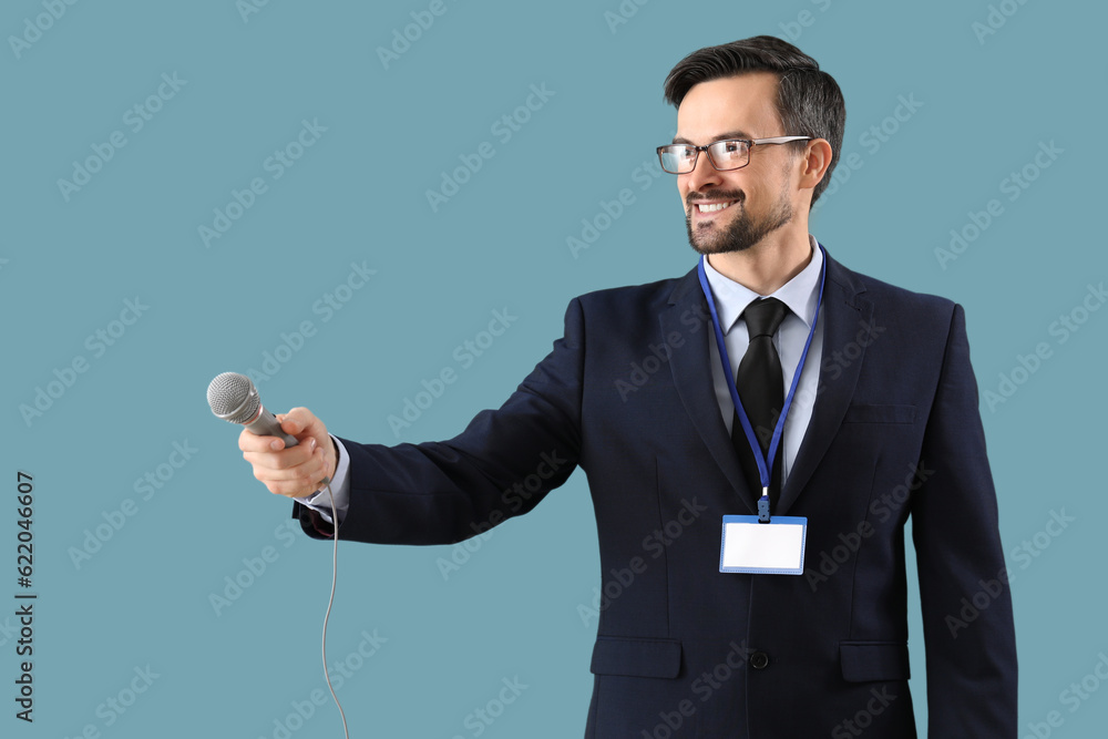 Male journalist with microphone on blue background