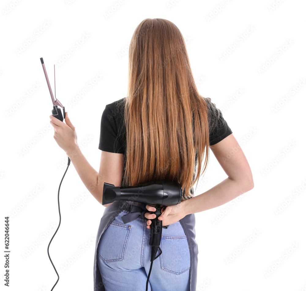 Female hairdresser with curling iron and dryer on white background, back view