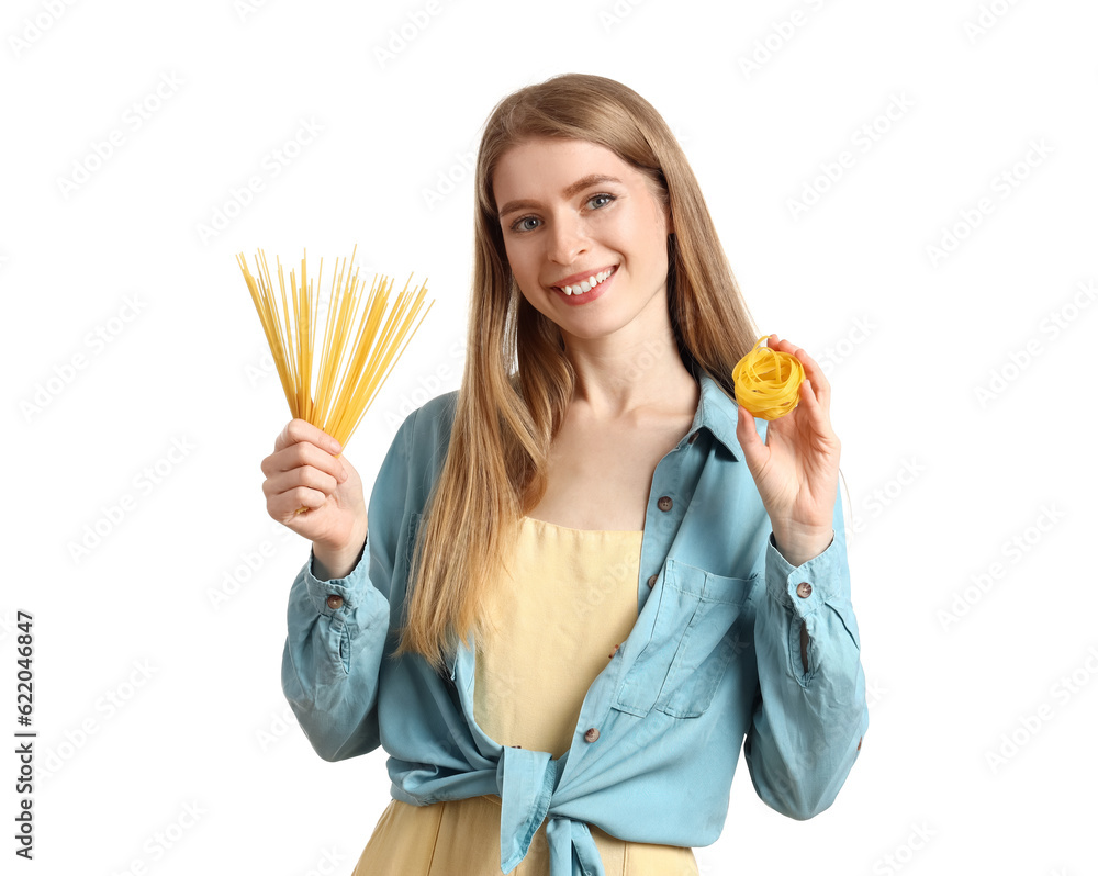 Young woman with raw pasta on white background