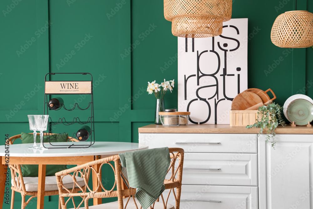 Interior of stylish kitchen with counters, table, chairs and lamps