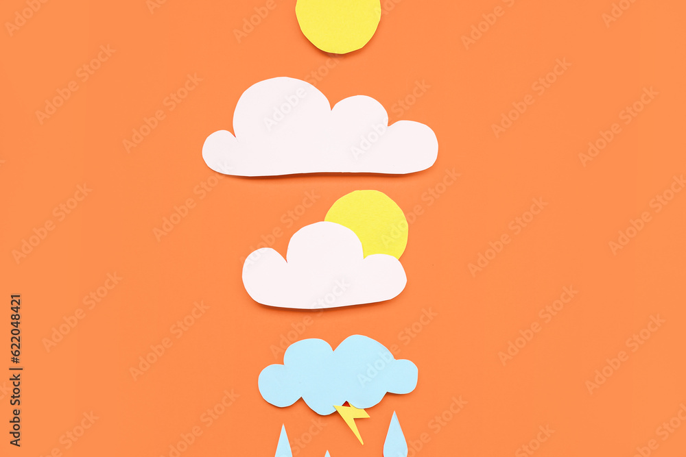 Paper sun with clouds and rain drops on red background. Weather forecast concept