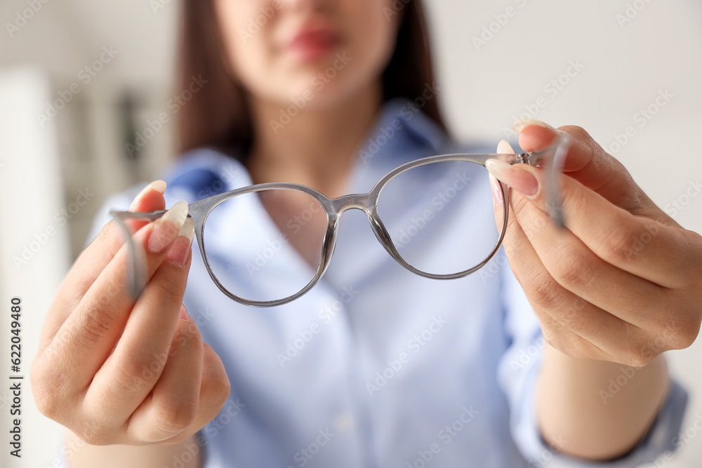 Young woman with glasses in office, closeup