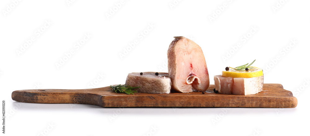 Wooden board with pieces of raw codfish on white background