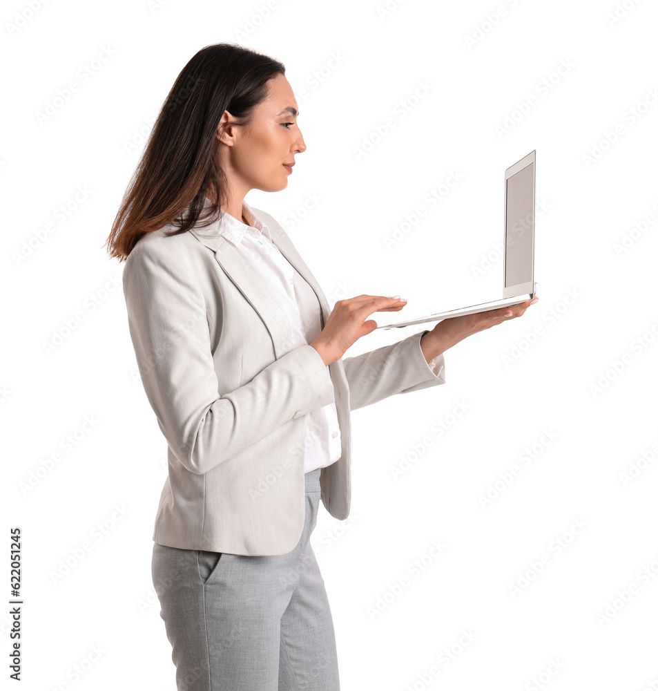 Young businesswoman in stylish suit using laptop on white background