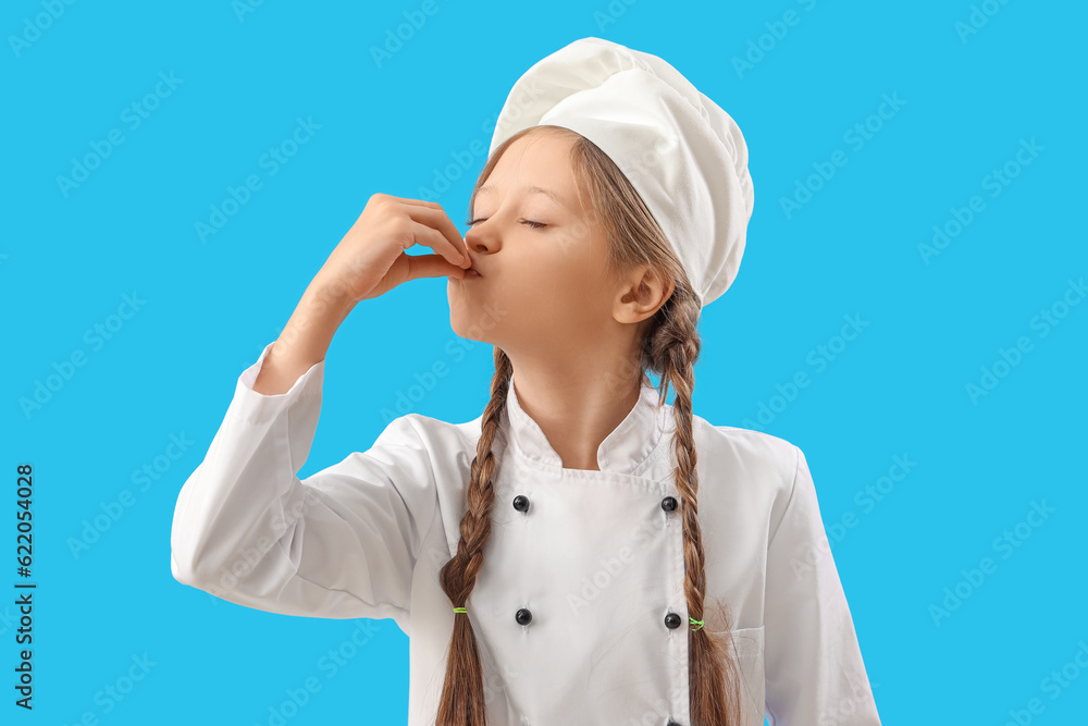 Little chef gesturing on blue background