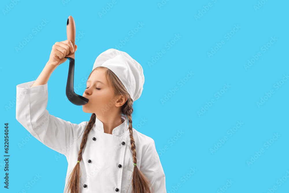 Little chef with ladle on blue background