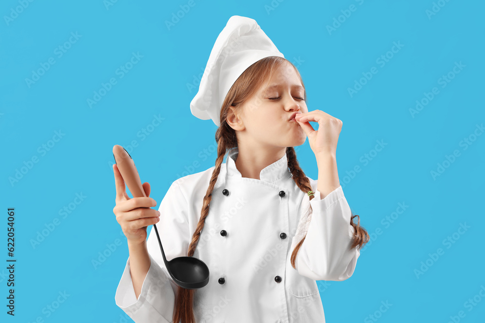 Little chef with ladle gesturing on blue background