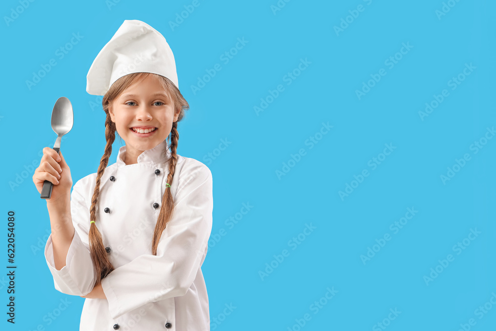 Little chef with spoon on blue background