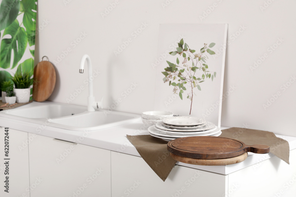 Cutting boards with plates and napkin on counter in kitchen