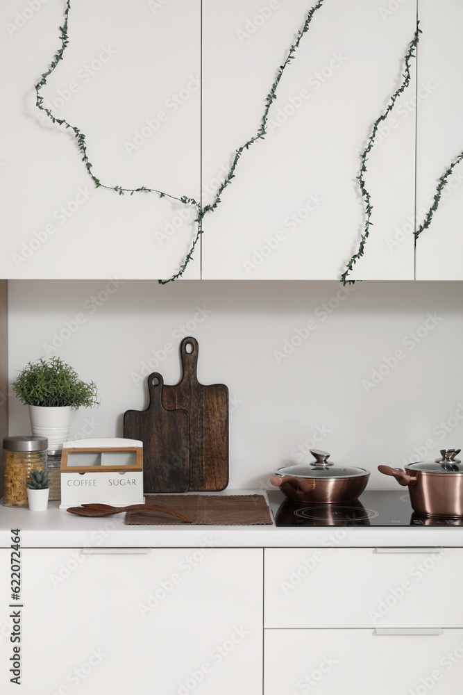 Cutting boards with utensils on counter in kitchen