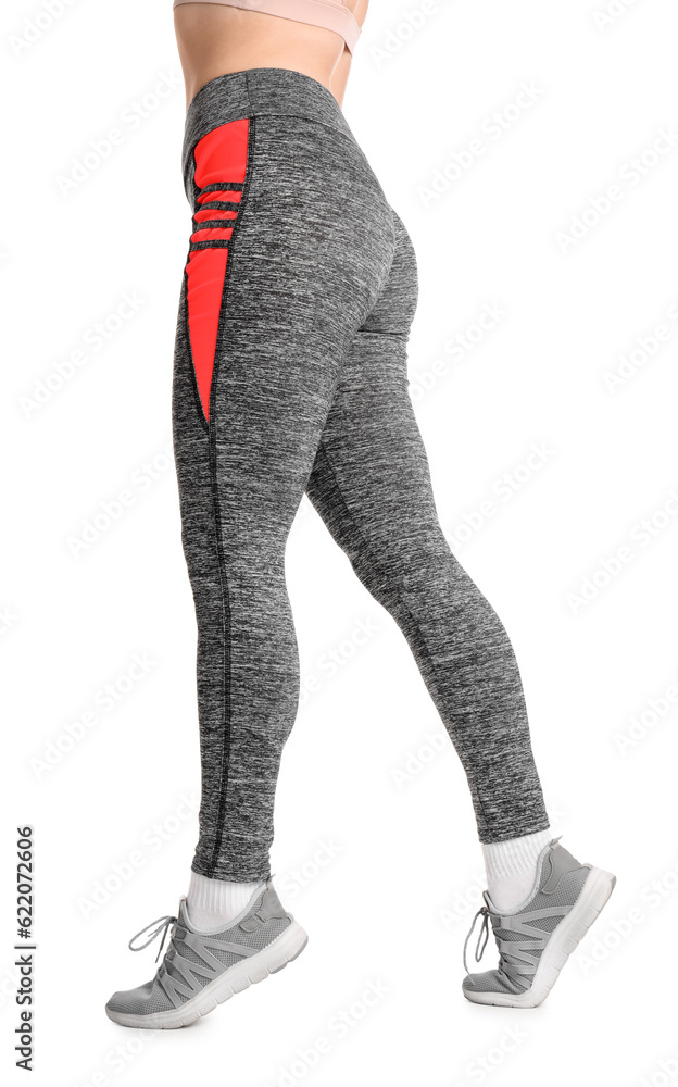 Sporty young woman in leggings on  white background