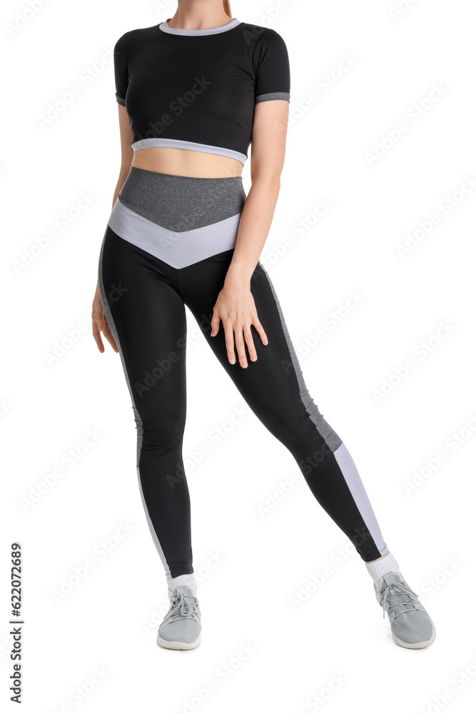 Young woman in sportswear on white background